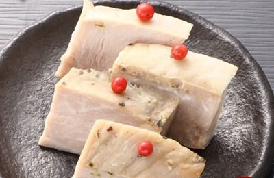 皿に盛ったローストポーク4切。ピンクペッパーがのっている